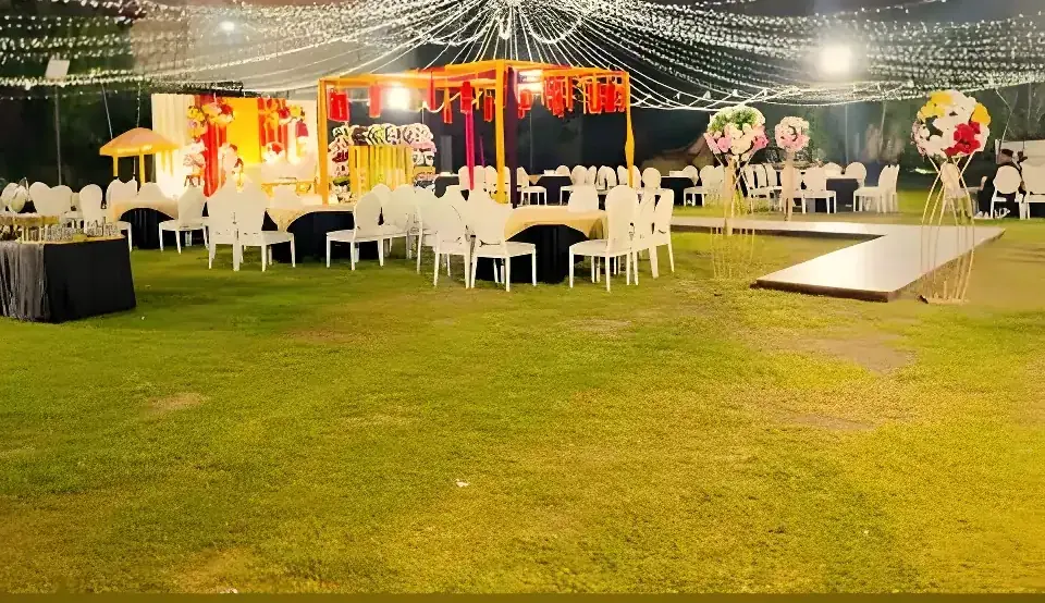 Fairy-light canopy over a lawn at night