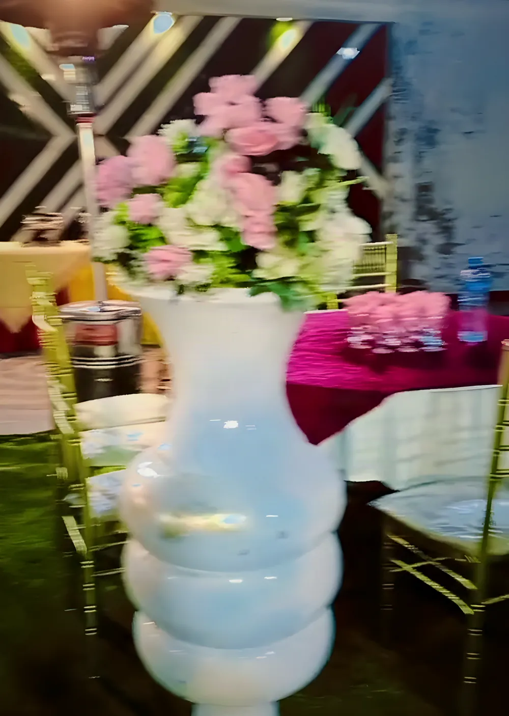 Pink flowers in a white vase on a table